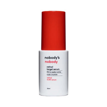 nobody's nobody retinol target serum bottle with red cap on black background